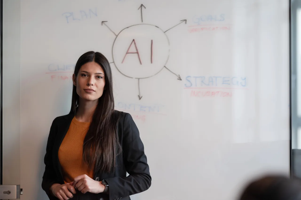 Woman beside a whiteboard connecting AI with planning, goals and strategy